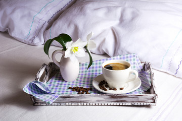 Fototapeta na wymiar Cup of fresh coffee with white lily