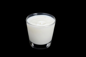 glass of milk on a black background    