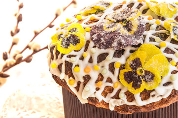 Easter cake covered with candied flowers and willow branches.
