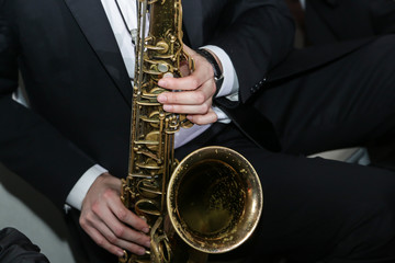 A man playing a saxophone instrument musician