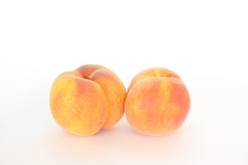 Two fresh whole peaches, isolated on white
