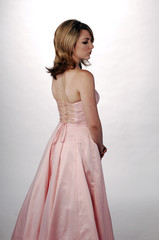 Fototapeta na wymiar Beautiful Woman in Pink Satin Designer Formal Gown