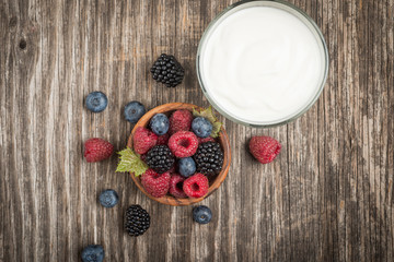 Top view of glasses with healthy breakfast, yogurt and berry fruit