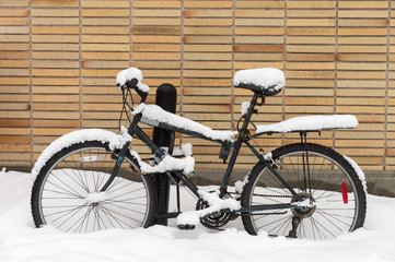 Bike covered in snow during snow storm