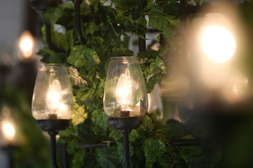 Wedding reception decorated with glass lamps and flowers 