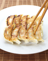 Japanese Gyoza , dumplings filled with ground meat and vegetables and wrapped in a thin dough