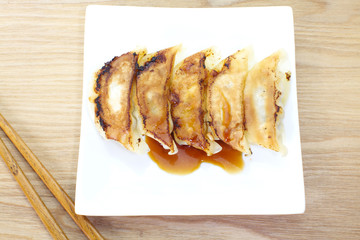 Japanese Gyoza , dumplings filled with ground meat and vegetables and wrapped in a thin dough