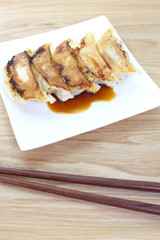 Japanese Gyoza , dumplings filled with ground meat and vegetables and wrapped in a thin dough