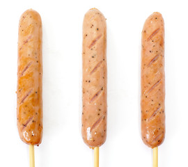 Delicious Hot sausage with wood skewer on white background
