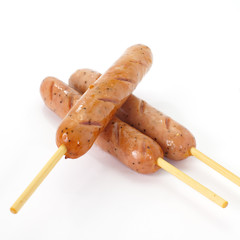 Delicious Hot sausage with wood skewer on white background
