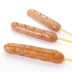 Delicious Hot sausage with wood skewer on white background