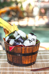 rice ball food design in wood bucket ,selective focus