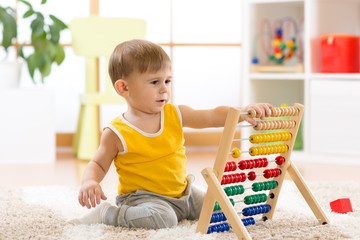 child boy playing with abacus