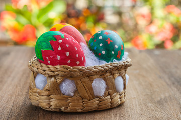 easter egg in basket on wood