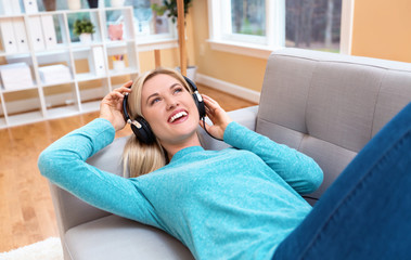 Young woman listening to music on headphones