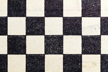 Fragment of a paper chess board. Abstract black and white background