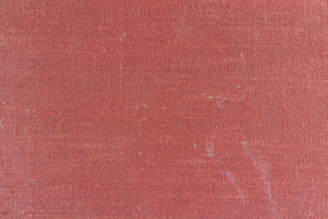 Old red textile texture with stains and fading. Abstract background