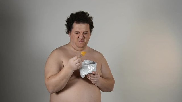 Funny man eating chips. 