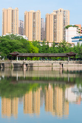 Fototapeta na wymiar Residential buildings reflecting in the water in Chengdu - China