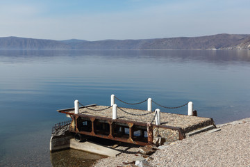 Fototapeta na wymiar Old pier on Lake Baikal, Listvyanka settlement, Siberia, Russia