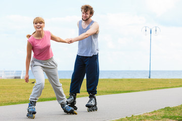 Woman encourage man to do rollerblading