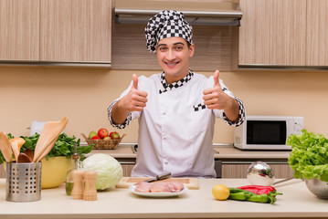 Young chef working in the kitchen