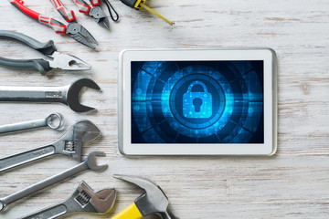 Fototapeta premium Web security and technology concept with tablet pc on wooden table