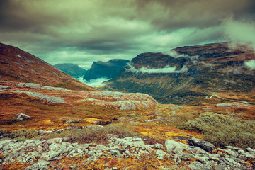 Mountain misty autumn landscape with dramatic cloudy sky Norway