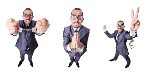 Funny businessman with handcuffs on white