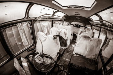 Haunted bus, murder scene, apocalyptic vision with blood covered sheets on seats and bench seats,...