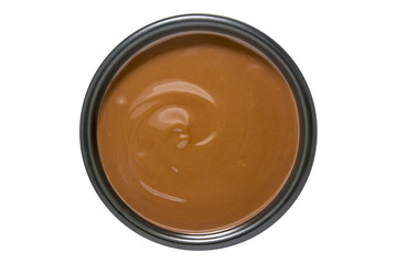 Bowl of melted chocolate isolated on white