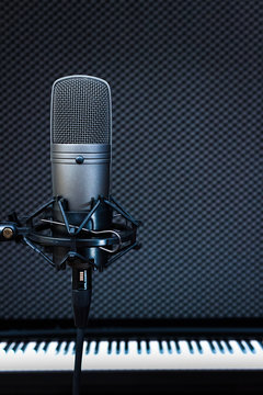 condenser microphone on piano background in recording studio