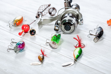 Fishing accessories on a wooden background.