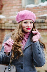 Emotional girl in gray coat and pink beret / The picture was taken in Russia, in the city of Orenburg, on Kobozev Street.