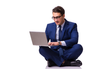 Businessman sitting on the floor isolated on white