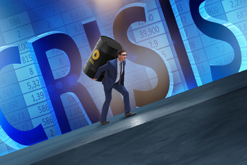 Businessman under the burden of oil barrel
