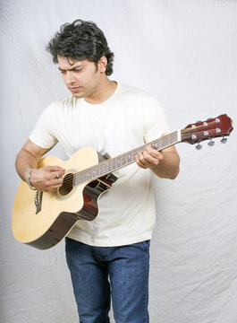 indian young male model with guitar