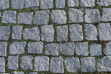 Texture of a gray uneven cobblestone.