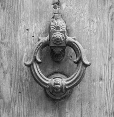 Details of an ancient Italian door, black and white.