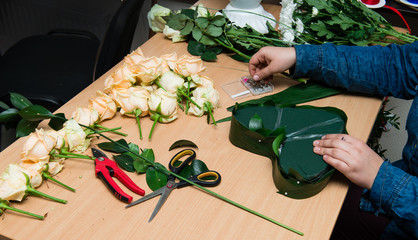 Florist making bouquet girl at work