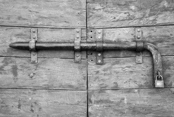 Details of an ancient Italian door, black and white.