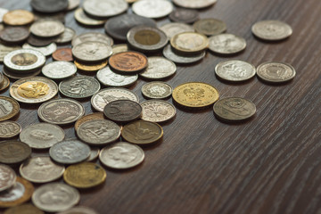 Different gold and silver collector's coins on the wooden table