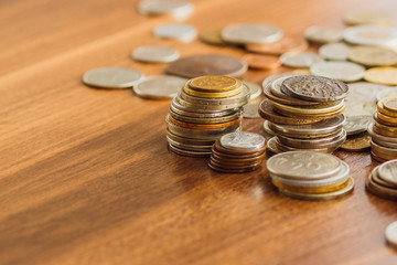 Different gold and silver collector's coins on the wooden table