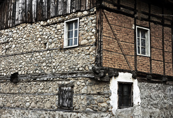 Old house stone paved road alley, wooden benches Bansko ski tourist centre of Bulgaria 