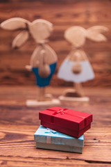 presents boxes in front of wooden easter bunnies couple