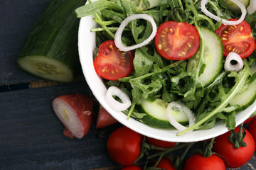 Bowl of salad on wooden table