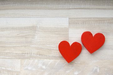two hearts on white wooden background