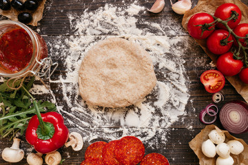 Cooking Pizza. Pizza ingerdients on the wooden table, top view