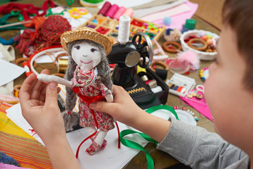 boy tailor learns to sew, dress for doll, handmade and handicraft concept