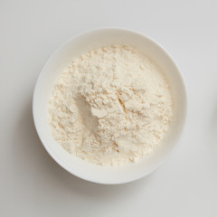 Flour in plate on white
